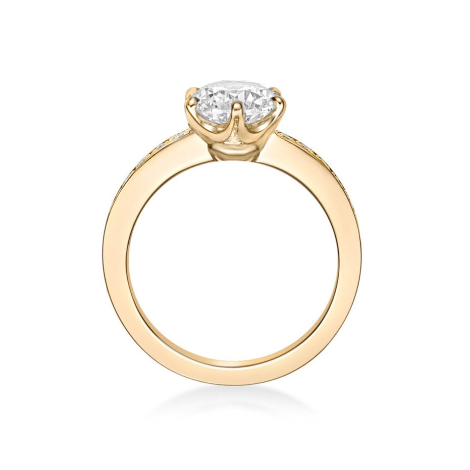1.50ct Round Brilliant diamond set in an 18K Yellow Gold 6-claw Crown setting with a micropave diamond eternity band