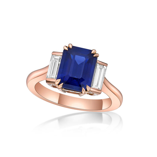 3.11ct Emerald Cut Sri-Lankan Blue Sapphire in a handmade 18K Rose Gold 3-stone engagement ring setting with straight baguette diamond side stones